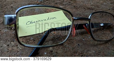 Observation Word Displaying On Paper Slip Behind The Specs Glass With Black Soil Background Business