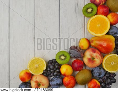 Fruit Frame Located On The Right On A White Plank Background. Close Up. Good Nutrition. Space For Te