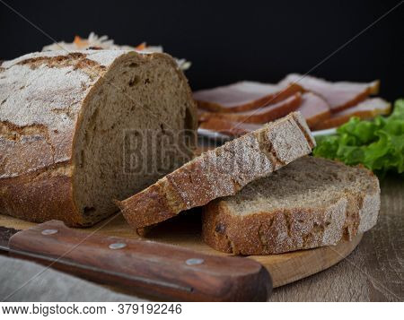 Sliced Bread On A Wooden Board With Meat And Salat