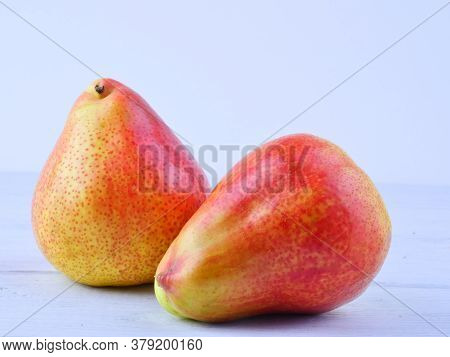 Two Ripe Pears On White Boards. Close-up. Proper Nutrition. Space For Text