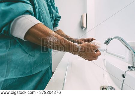 Surgeon Washing Hands Before Operating Patient In Hospital - Medical Worker Getting Ready For Fighti