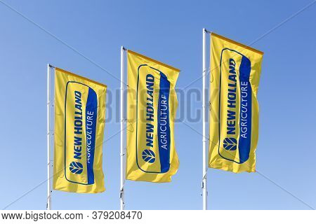 Autun, France - July 5, 2020: New Holland Agriculture Flags. New Holland Is A Brand Agricultural Equ