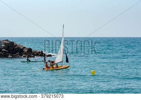 Sitges, Catalonia, Spain: July 28, 2020: People On The Paseo Maritimo In The City Of Sitges In The S
