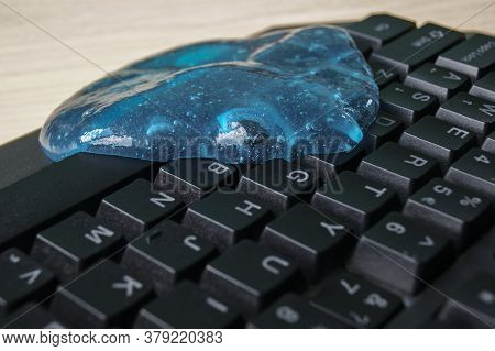 Blue Soft Gel Cleaning Dust On Keyboard. Concept Cleaning Your Computers Keyboard.