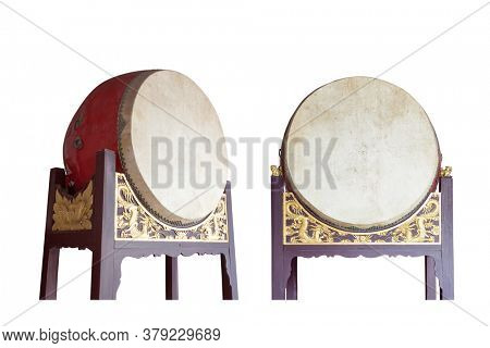 Traditional Chinese big drums on wooden frame with dragon relief isolated on the white background, this traditional drums were usually pounded  in sacrificial rites or festivals in ancient times