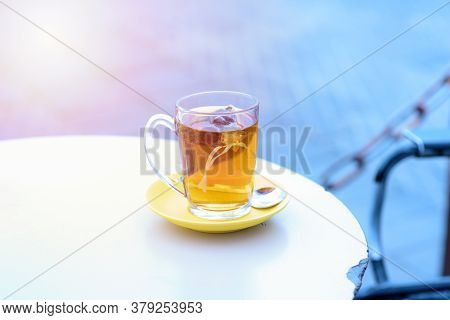 Tea On White Table Sea Port Background , Warm Tone. Tea Bags In Glass On A Restaurant In The Port Ne
