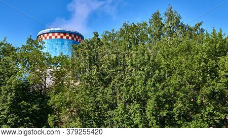 Cooling Tower Heat Station Out Behind Trees. Color