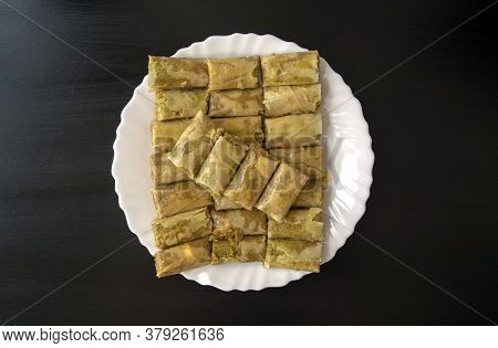 Traditional Turkish, Arabic, Middle Eastern Baklava. Top View. Arabic Baked Sweets In White Plate On