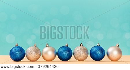 New Year. Christmas Holiday And Festive Event Concept. Glittery Balls For Decor Isolated On Blue Bac