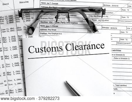 Paper With Text Customs Clearance On A Financial Tables With Glasses