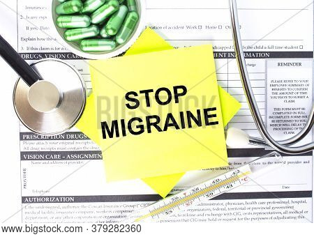 Text Stop Migraine In A Notebook On Medical Forms With A Phonendoscope And Green Pills