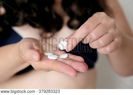 Woman With Pills, White Tablet In Female Hand. Girl With Long Curly Hair Taking Medication, Concept 