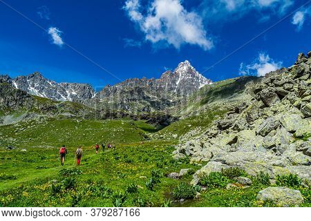 Hiking In The Monviso Valleys Between Streams, Waterfalls And Flowery Pastures