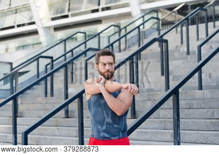 Preparing His Muscles. Fitness Man Warming Up In The Gym. Having A Good Stretch. Handsome Man In Spo