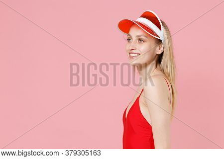 Side View Of Smiling Young Blonde Woman Girl In Red One-piece Swimsuit Cap Posing Isolated On Pink B