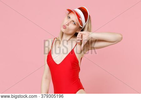Confused Displeased Young Blonde Woman Girl In Red One-piece Swimsuit Cap Posing Isolated On Pink Ba
