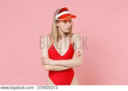 Worried Confused Young Blonde Woman Girl In Red One-piece Swimsuit Cap Posing Isolated On Pink Backg
