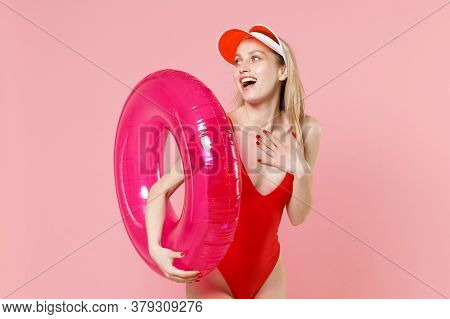 Excited Young Blonde Woman Girl In Red One-piece Swimsuit Cap Isolated On Pink Background. People Su