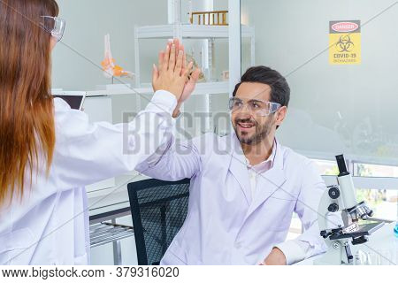 Doctor And Microbiologist With Vacuum Tubes For Samples With Covid 19 Infection Atypical Pneumonia V