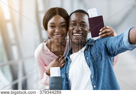 Memorable Trip. Happy Black Couple Capturing Selfie Photo At Airport Terminal, Smiling At Camera, Cl