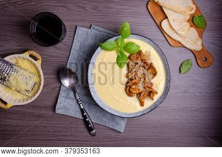 Traditional Polenta With Mushrooms And Cheese In A Dish On A Dark Wooden Background. Selective Focus