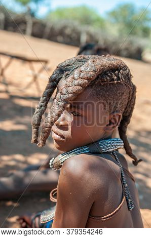 Epupa, Namibia - May 27, 2011: A Himba Girl With Traditional Hair Locks Posing For Photographers At 