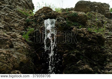 A Waterfall, A Fall Of Water Originating From Rock