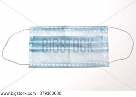 One Blue Face Protection Medical Mask Isolated On White Background. Prevention Of The Spread Of Viru