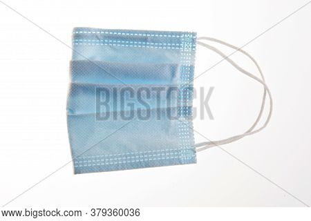 One Blue Face Protection Medical Mask Isolated On White Background. Prevention Of The Spread Of Viru
