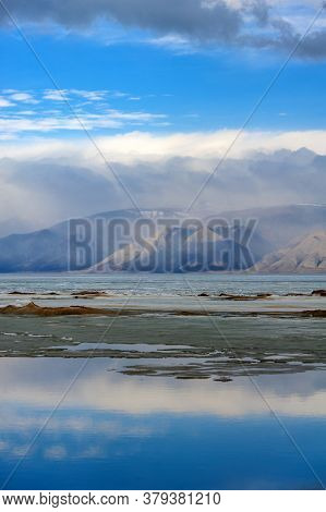 Baikal, Mountains And Ice On The Lake, Clouds Reflecting In The Water