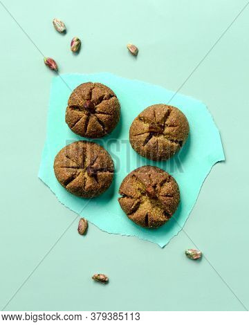 Traditional Homemade Moroccan Festive Ghoriba Cookies With Pistachio Nuts On Trendy Mint Color Backg