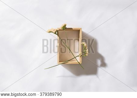 Top view of voile fabric background with flowers in two corners with space for text