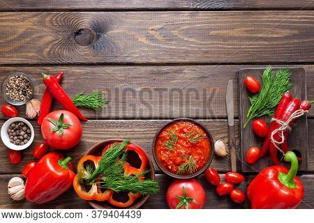 Balkan Sauce Ajvar And Ingredients For Its Preparation On A Wooden Table. Serbian Traditional Food