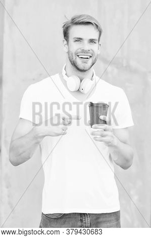 Try This. Happy Man Pointing At Hot Cup Outdoors. Pointing Gesture To Takeaway Drink. Index Finger P