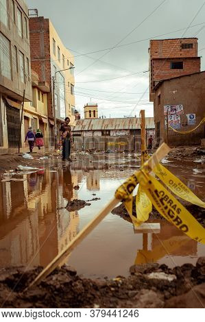 Desaguadero, Puno / Peru - April 4 2016: Young Man With A Skateboard In A Desolted Teared Apart Stre