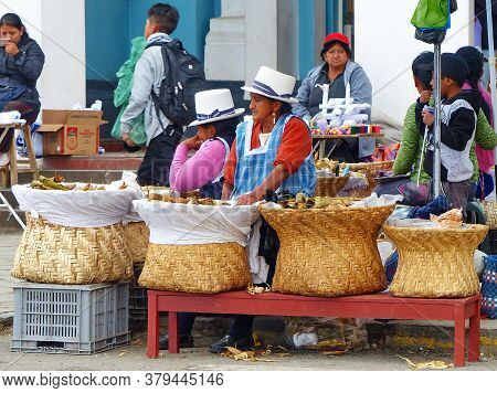 Cuenca, Ecuador - September 23, 2018: Street Market In Cuenca. Local Women With A Big Baskets Sell S