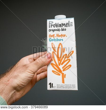 Paris, France - May 29, 2020: Man Hand Holding Against Gray Background Package With Provamel Organic
