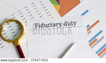 Paper With Fiduciary Duty On A Table With Charts