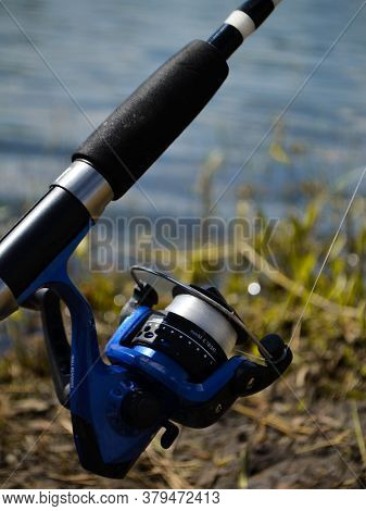 Fishing Rod Reel Close-up On The River Bank