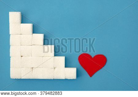 Laid Out A Ladder Of Sugar Cubes, A Red Heart At The Bottom Of The Stairs On A Blue Background, Copy