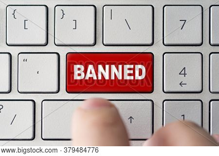 Admin Bans The User. The Red Button On The Keyboard Of A Notebook With The Inscription Of Banned. Th