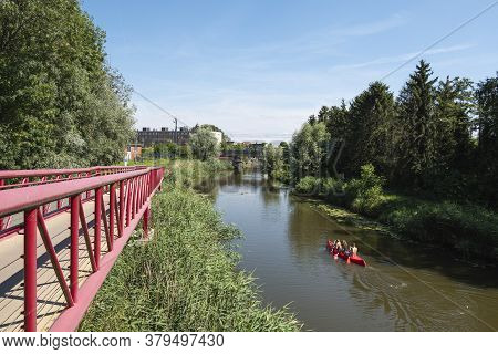 Lokeren, Belgium, July 13, 2020, Red Canoe Sails On The Water Of The Durme To The City Center