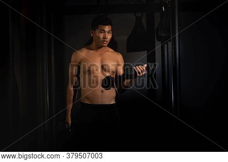 Handsome Man Raising Dumbbell Up And Down,doing Exercise For Buit Muscle,fit And Firm Body