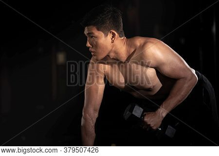 Handsome Man Raising Dumbbell,doing Exercise For Buit Muscle,fit And Firm Body,model Posing