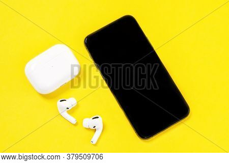 Rostov, Russia - July 06, 2020: Smartphone Apple Iphone 11 Pro And Wireless Headphones With Charging