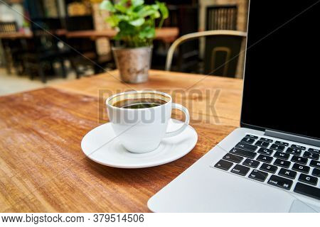 Hot Healthy And Tasty Coffie Drink On The Cup With Notebook