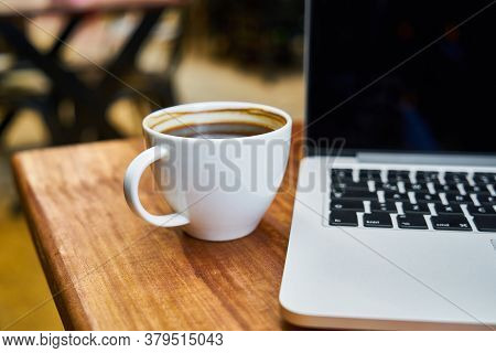 Hot Healthy And Tasty Coffie Drink On The Cup With Notebook