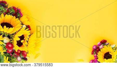 Sunflowers And Aster Fresh Flowers Frame , Top View On Yellow Background With Copy Space, Naturall F