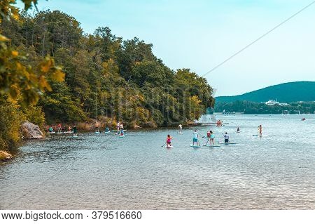 Brno Prygl, Czech Republic - August 2, 2020: Paddle Group On The Lake. Paddleboard People On Stand U