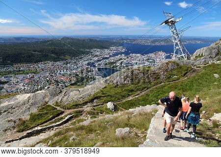 Bergen, Norway - July 23, 2020: People Hike Ulriken Mountain Trail Overlooking City Of Bergen, Norwa